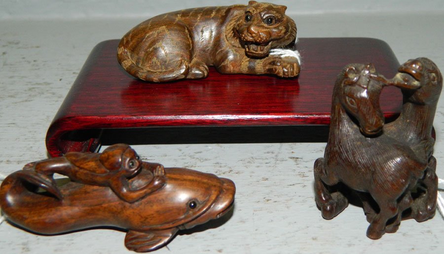 Netsukes.: Netsuke of a pair of horses, tiger, and a carp with monkey on it's back. Tallest 2 3/4" with stand.