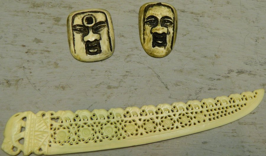 Book marker and (2) flat ivory mask netsukes.: Book marker and (2) flat ivory mask netsukes. Book marker 6 3/4" long.