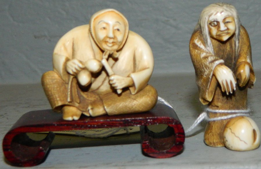 Ivory netsuke of a wink eye and a lady.: Ivory netsuke of a wink eye and a lady with instrument on stand. Wink eye 2 1/2" tall, lady 2 1/4" tall.