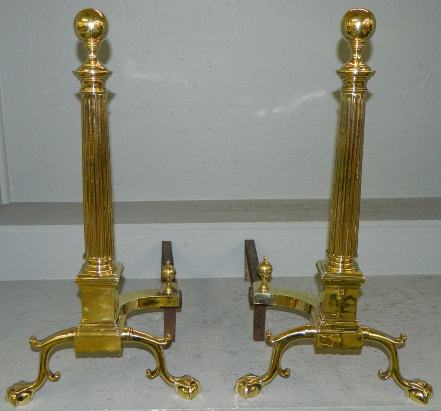 Pair of polished cannonball claw foot andirons.: Pair of polished cannonball claw foot andirons with columns. 24 1/2" tall.