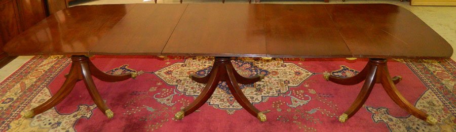 Mah three pedestal banquet table with 2 leaves.: Mahogany three pedestal banquet table with two leaves. 128 1/4" long x 45 1/4" wide x 28 1/4" tall.
