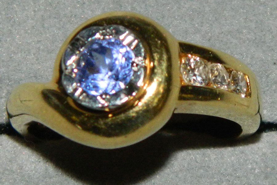 Lady's two-tone, tanzanite and diamond ring.: Lady's two-tone, asymmetrical tanzanite and diamond right hand ring, marked Platinum and 18K. Appraised at $2,350.