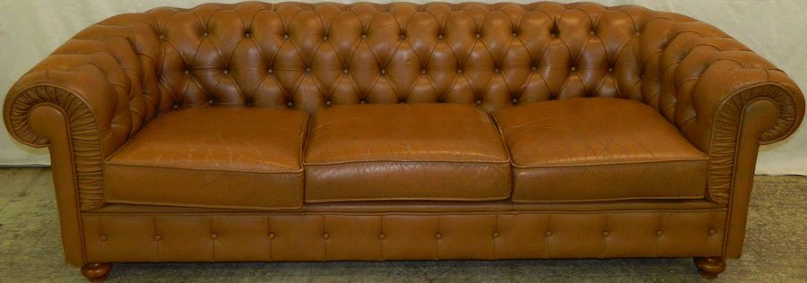 Tufted leather Chesterfield sofa in caramel.: Tufted leather Chesterfield sofa in caramel. 84" long x 33" deep.