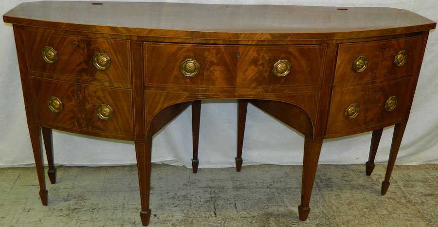 19th C bowfront mah inlaid Hepplewhite sideboard.: 19th Century bowfront mahogany inlaid Hepplewhite sideboard with one cellarette drawer (has original tole liner). 72" wide x 21" deep x 37" tall.