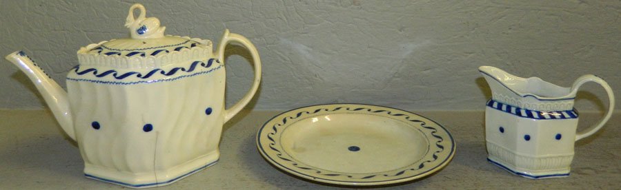 Three pieces of 19th Century Staffordshire.: Three pieces of 19th Century Staffordshire. Includes teapot with swan finial, cream jug and plate. The teapot has a crack in the base. Teapot 6 1/2" tall, creamer 3 1/2" tall, plate 8 1/2" diameter.