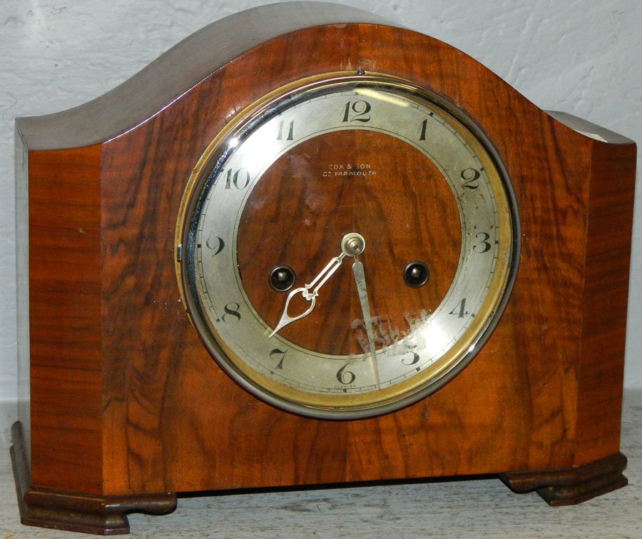 8 day English crotch mahogany shelf clock.: 8 day English crotch mahogany shelf clock by Cox & Son. 11 1/2" wide x 4 3/4" deep x 9" tall.