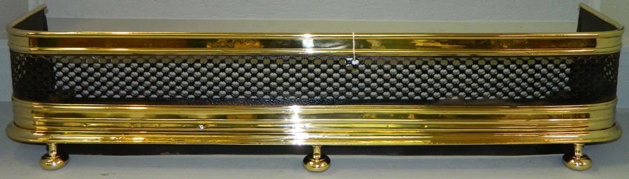 Polished brass and iron pierced fender.: Polished brass and iron pierced fender. 46 1/2" long x 11" deep.