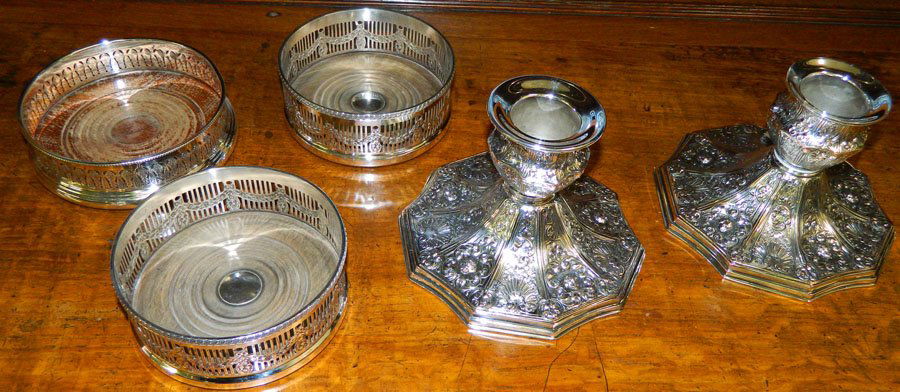 Pair silverplate candlesticks & (3) wine coasters.: Pair of silverplate candlesticks by International and (3) silverplate wine coasters. (1) Wine coaster Barker Ellis and (2) Sheffield. Candlesticks 4 1/2" tall, coasters 5" diameter .