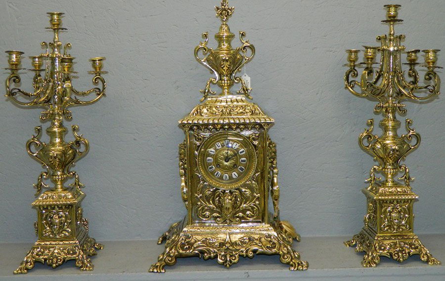 French bronze garniture set with clock.: French bronze garniture set with clock, all have jellif heads. 24" tall.