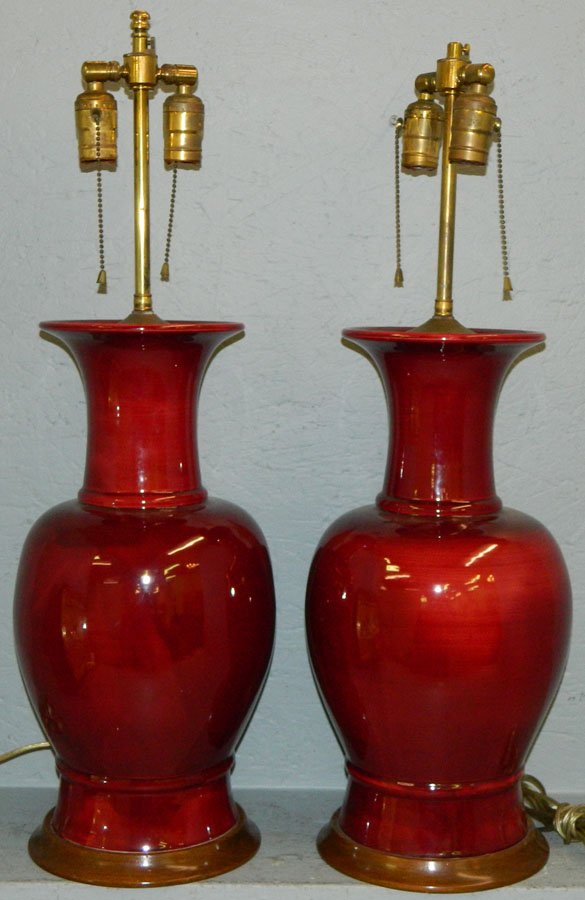 Pair of ox blood porcelain lamps.: Pair of ox blood porcelain lamps. 27 1/2" tall to finial.
