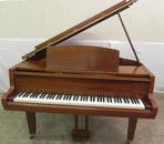 Mahogany Yamaha baby grand piano w/ stool.