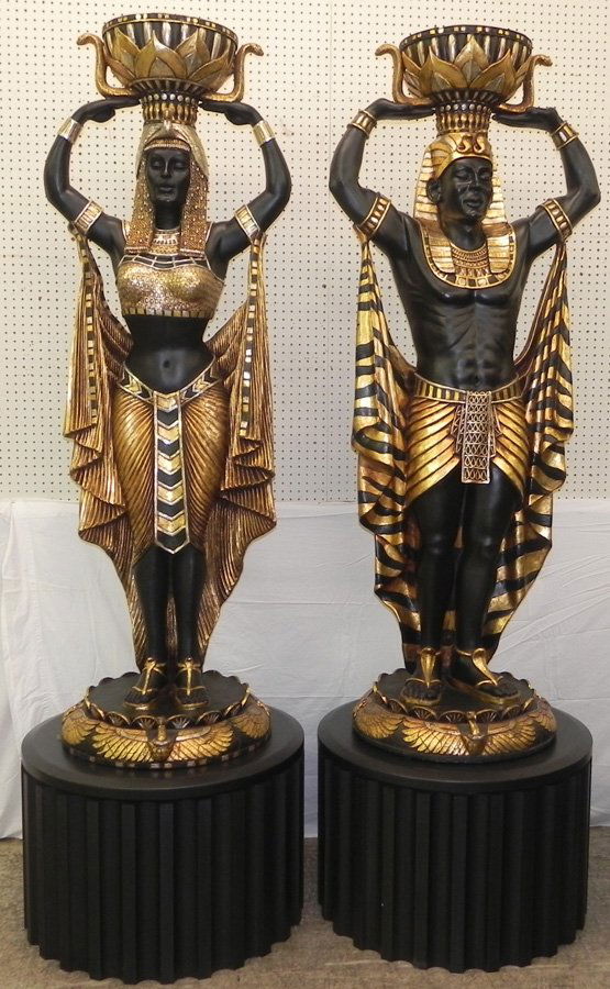 Pair of life sized Egyptian figures on stands.