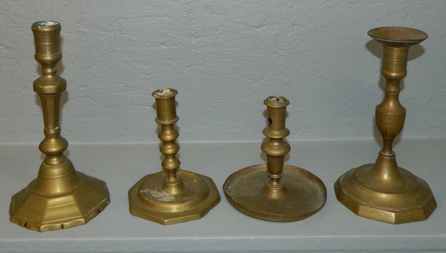 4 odd 18th C. brass candlesticks.: 4 odd 18th C. brass candlesticks. 5" to 8 1/2" tall.