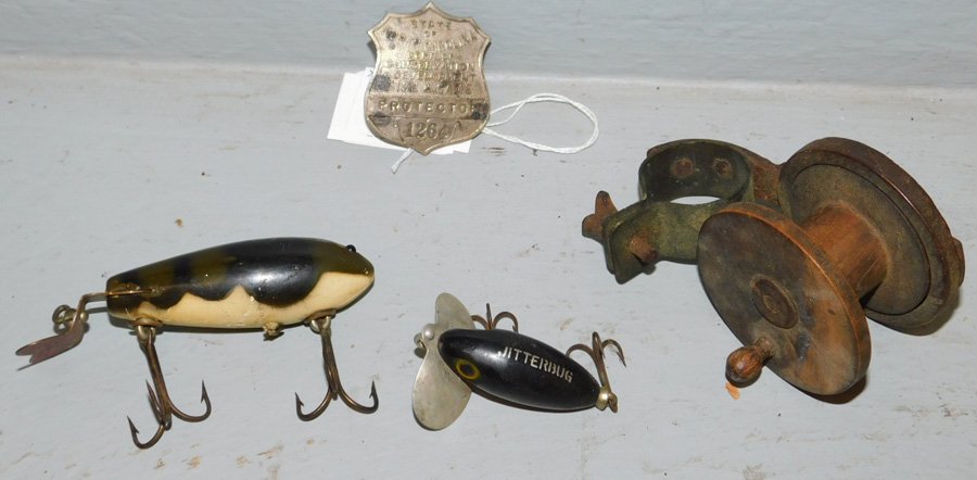 2 fishing lures, wooden reel, NC Warden badge. (1 of 1)