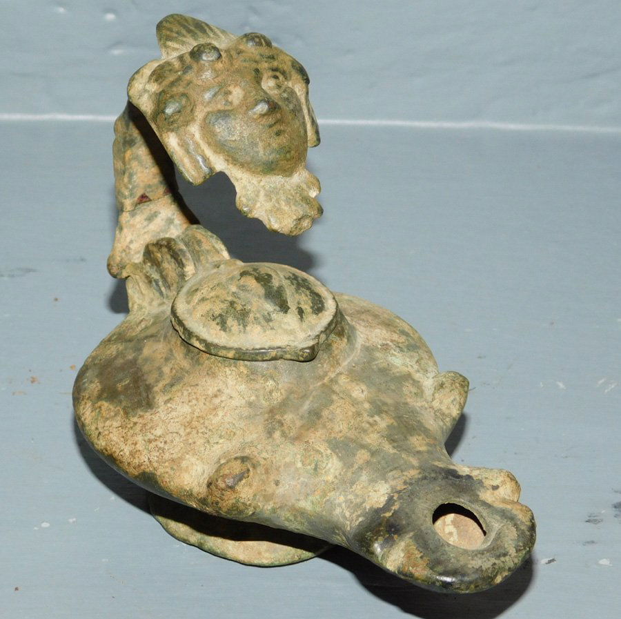 Pre-18th C. oil or grease lamp with face detailing.: Pre-18th C. oil or grease lamp with face detailing. 4" tall.