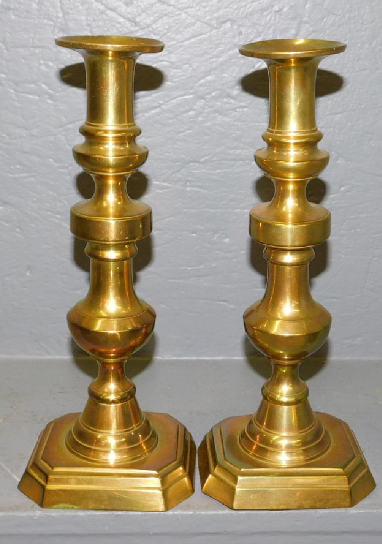 Pair of early brass push up candlesticks. 12" tall. (1 of 2)