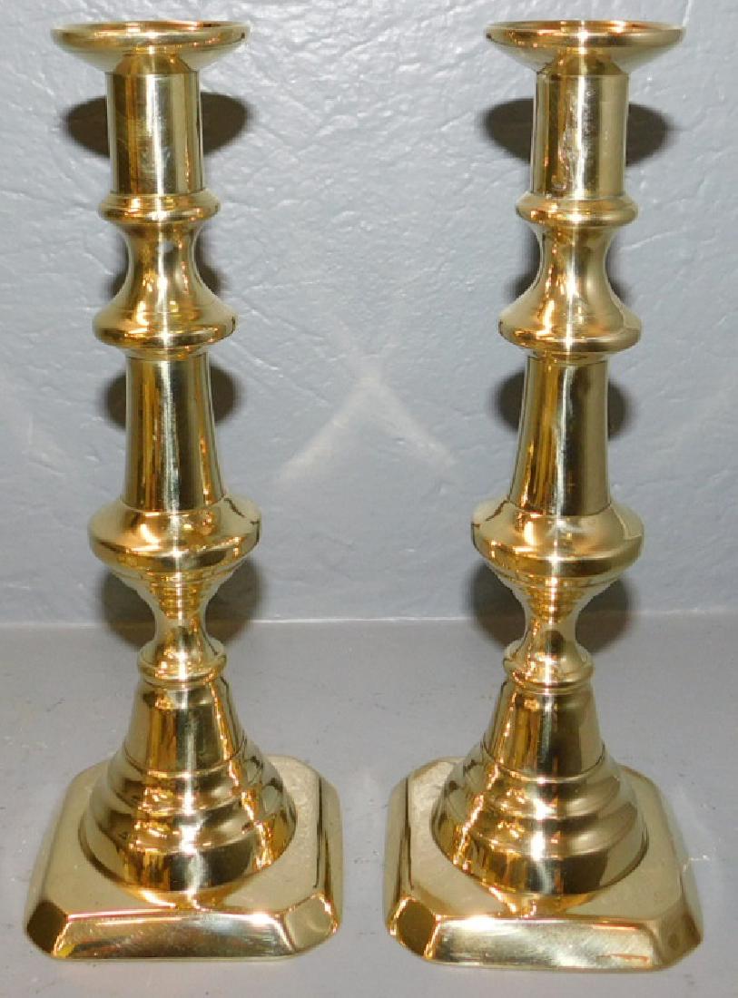 Pair of early brass push up candlesticks (1 of 2)
