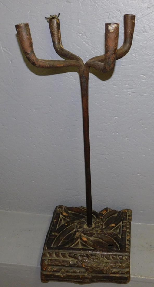 Cast iron 4 light candle stand on carved base. (1 of 3)