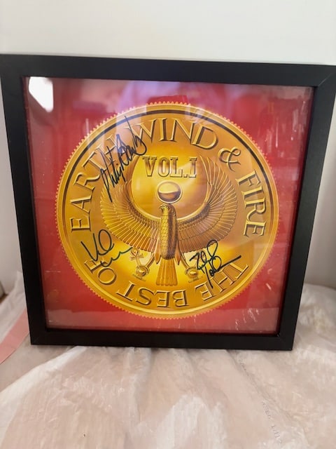 Earth Wind and Fire The Best Of: Signed record album by the members of Earth Wind and Fire. All signatures bold and clear Framed 14 x 14 Album has some rub marks on top