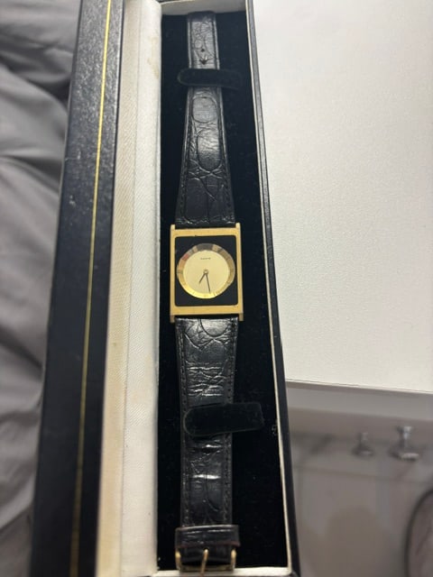 Womens Quartz Watch: Black and gold with black leather band