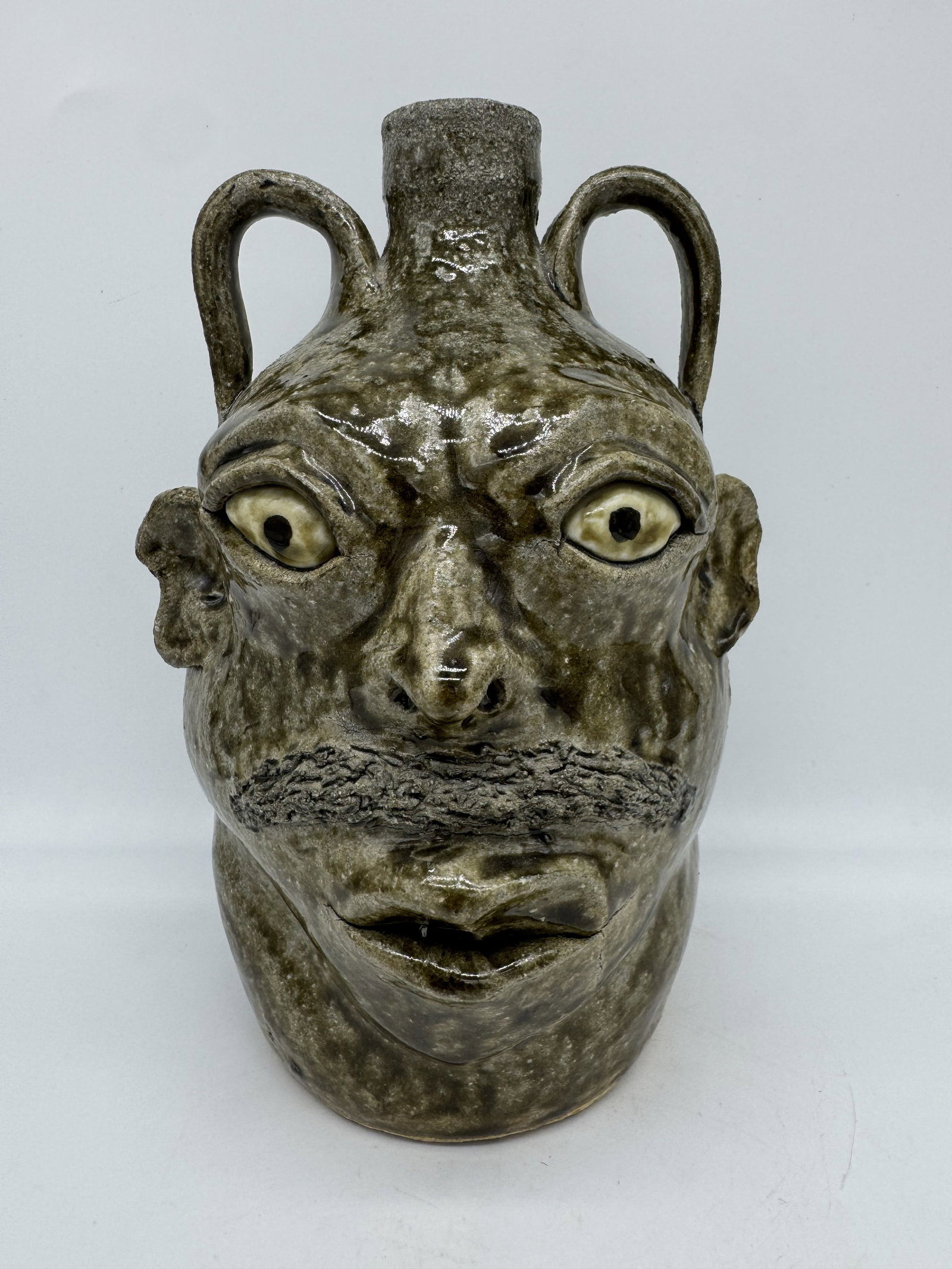 David Meaders Double Face Jug: An early woodfired double face jug by David Meaders, made at the old Martin home place. This example features two distinct faces, including one with a bold mustache, giving the piece a strong