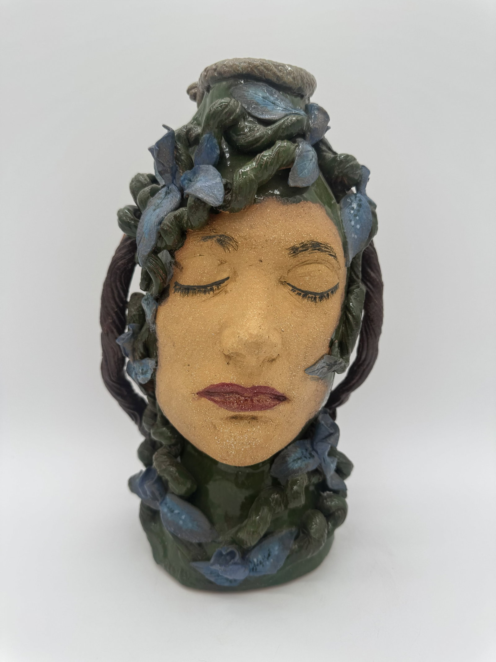 Beckie Barden Double Face Jug: A double face jug by Beckie Barden, featuring the “maiden and crone” motif with one face on each side. The piece is further decorated with a snake, along with leaf, vine, and acorn elements
