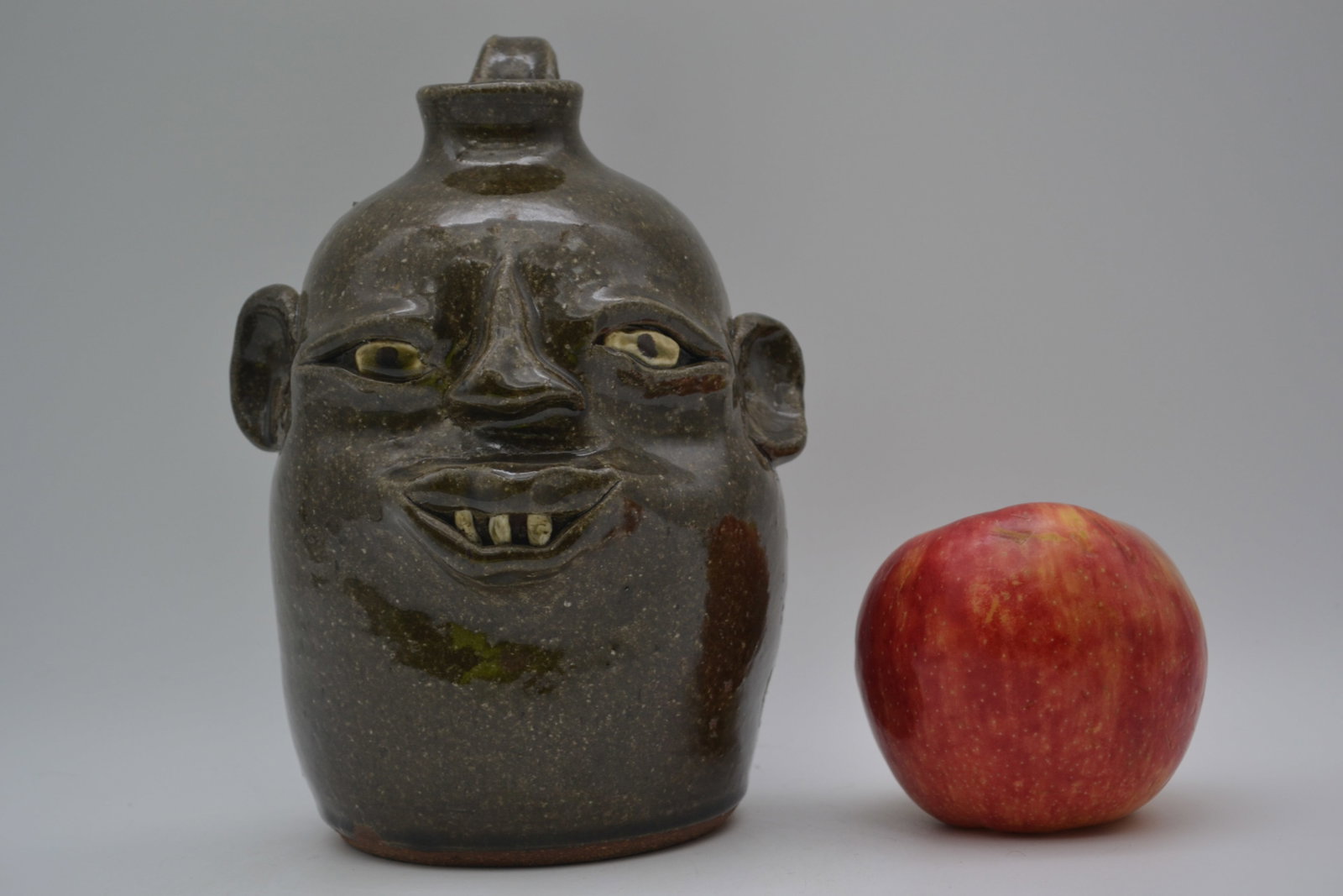 David and Flossie Meaders Face Jug: A special collaborative jug by David and Flossie Meaders, dated July 14, 2011. This meaningful mother-and-son collaboration features a jug turned by David, with the face decoration created by Flossie.