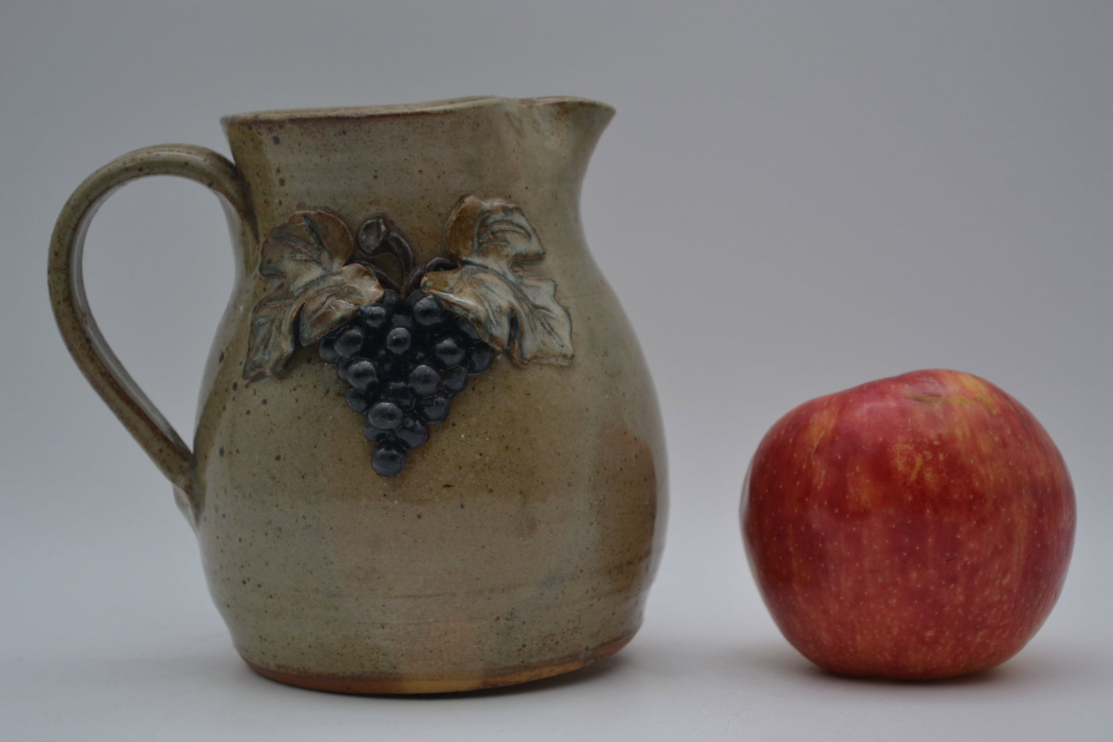 Wilford Dean Decorated Pitcher: A grape, leaves, and vine decorated pitcher by Wilford Dean, dated May 1993. The grape decoration is well executed, with excellent detail in the leaves and vine work, giving the piece strong visual ap