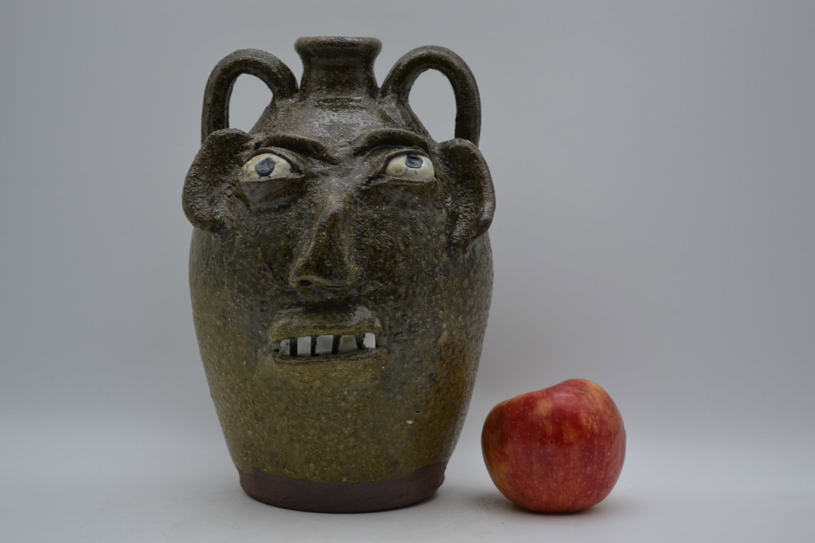 Burlon Craig Face Jug: A double-handled face jug by Burlon Craig. Finished in a wonderful mottled frogskin glaze, this jug has exceptional depth, texture, and visual appeal. The glaze gives the piece a distinctive surface