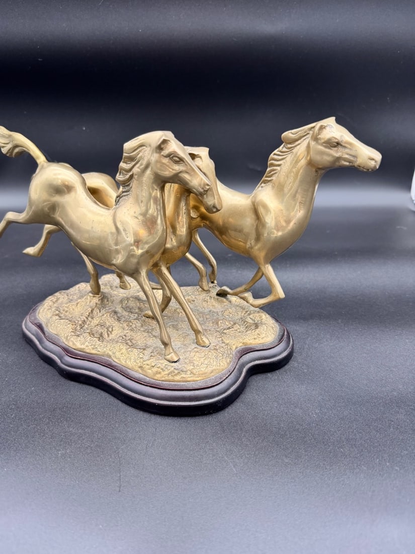 Brass Running Wild Horses Statue - Vintage: Vintage brass sculpture depicting three running/galloping horses, mounted on a wooden base. Typically produced in the mid to late 1970s. The third horse with legs in the air moves a bit, it does not