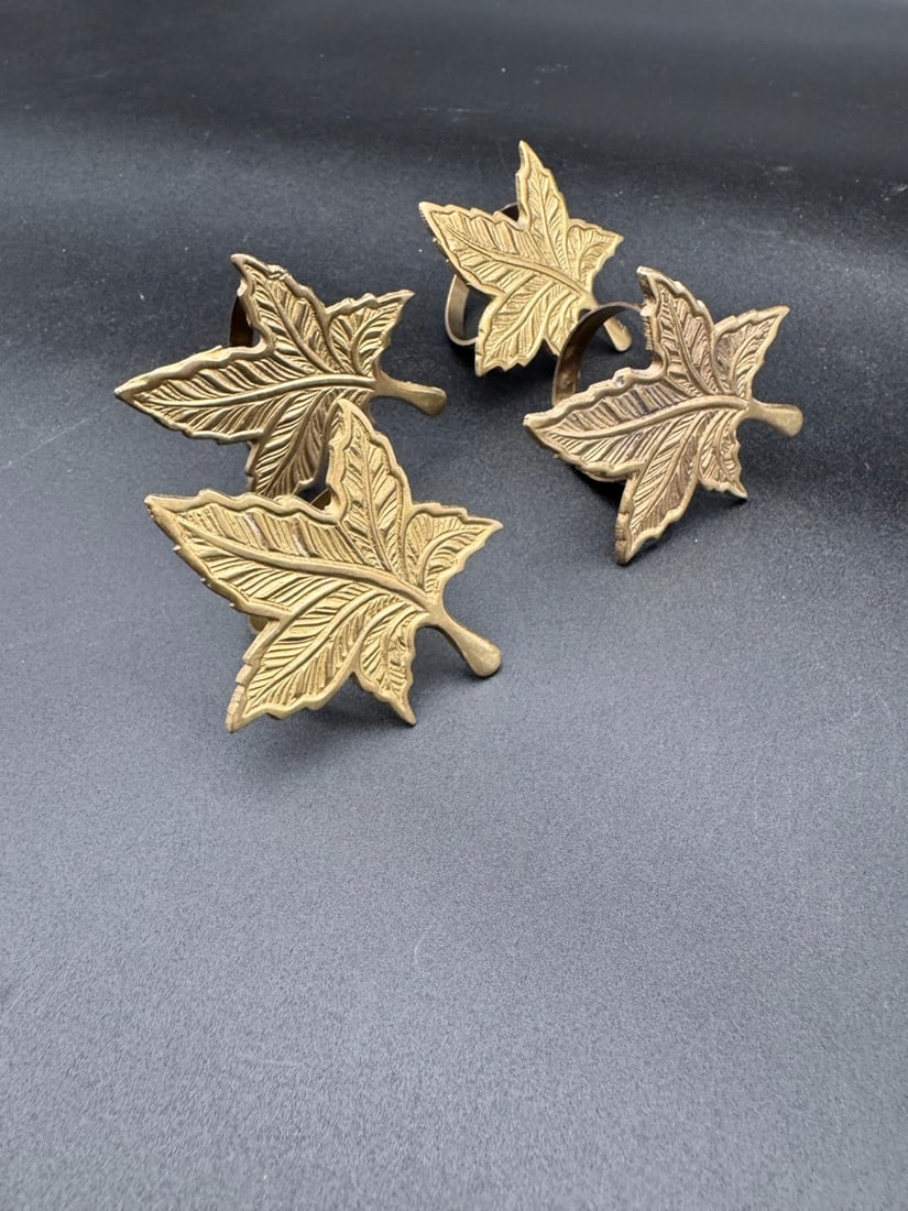 Brass Maple Leaf Napkin Holders (Set of 4): Vintage brass napkin rings shaped like maple leaves featuring a vein rich detail and texture. A touch of elegance to the dinner table, and perfect for any autumn night. Set of 4