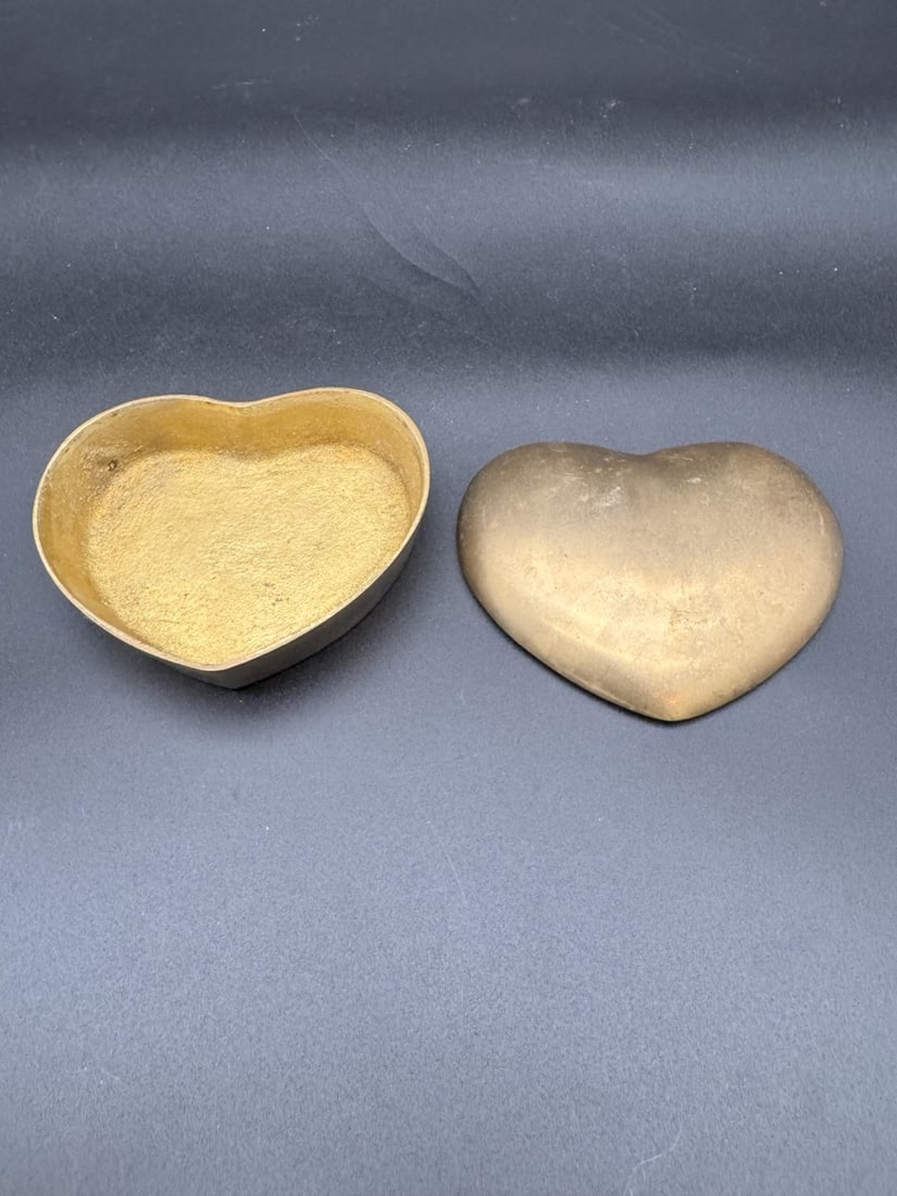 Brass Mid Century Brass Heart Trinket Box: A classic vintage gift. Vintage brass heart-shaped trinket box with lid. Mid century modern era, used for storing jewelry or small treasures.