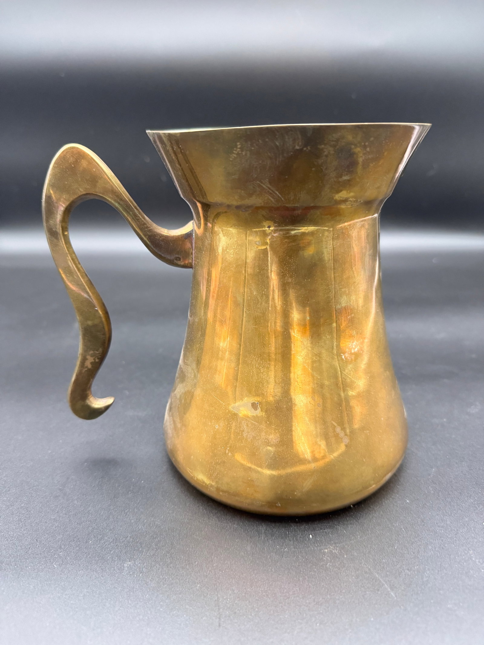 Vintage MCM Brass Pitcher with Curved Handle: Vintage solid brass pitched, mid century modern design with serpentine handle.
