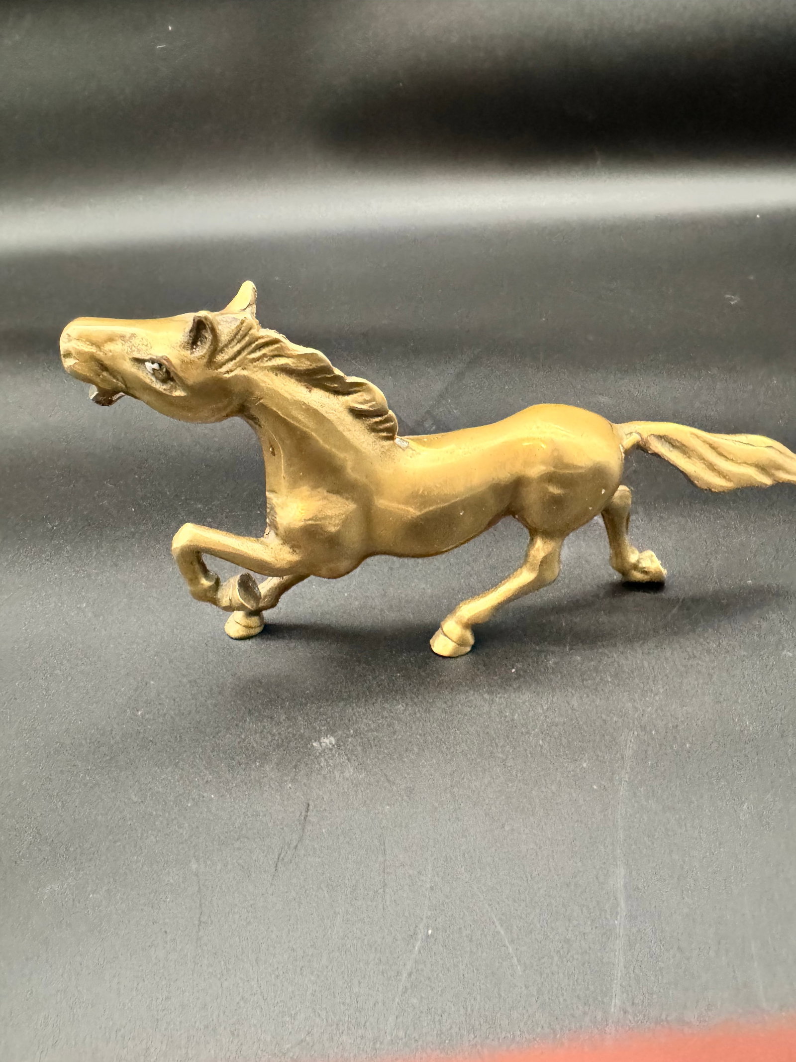 Vintage Brass Running Horse: Solid brass running horse showing a running or prancing stallion pose. Mid century modern decor style with a natural patina that can be polished or kept as is for a vintage look.