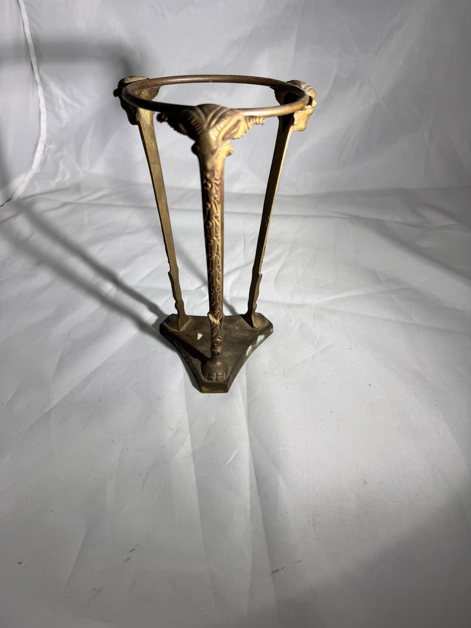 Vintage Brass Stand with Ram Head Motifs: Vintage mid-century solid brass decorative stand with ram head motifs. Can be used with plates, bowls, vases, plant stand, candles and crystal or glass, orbs or spheres. Features three tripod legs