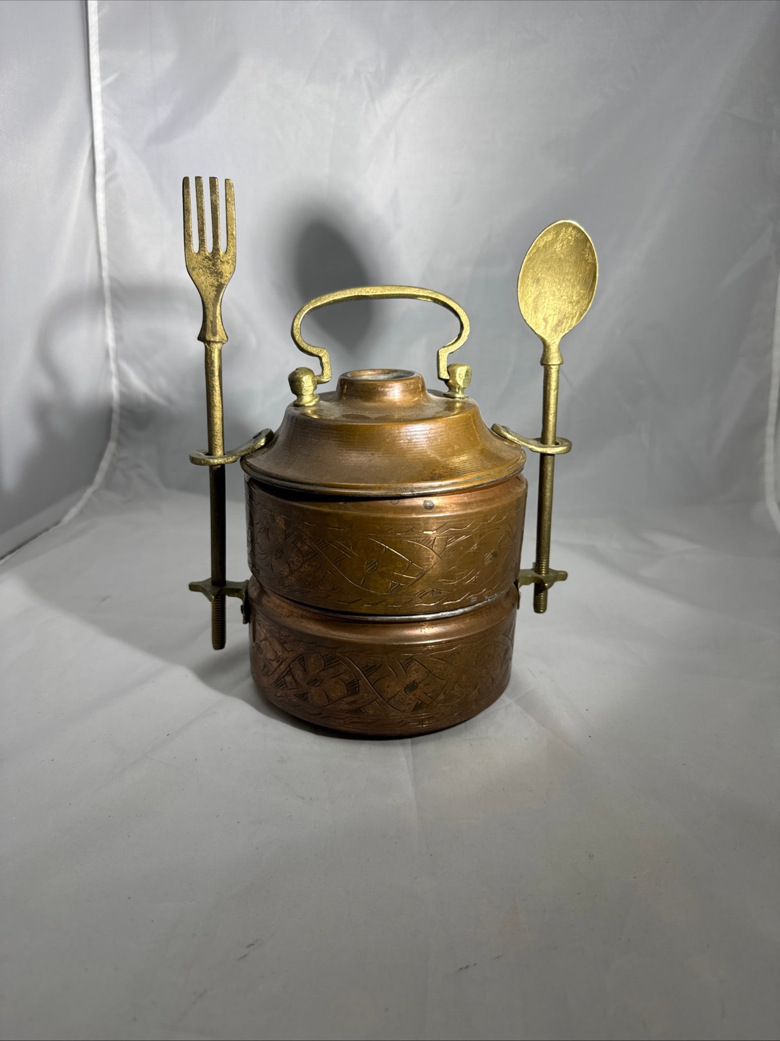 Vintage Copper and Brass Stacking Lunch Box: This item is a Southeast Asian multi-tiered brass Tiffin stacking lunch box crafted from copper with brass utensils and engraved. Features hand-engraved floral and geometric patterns on the copper