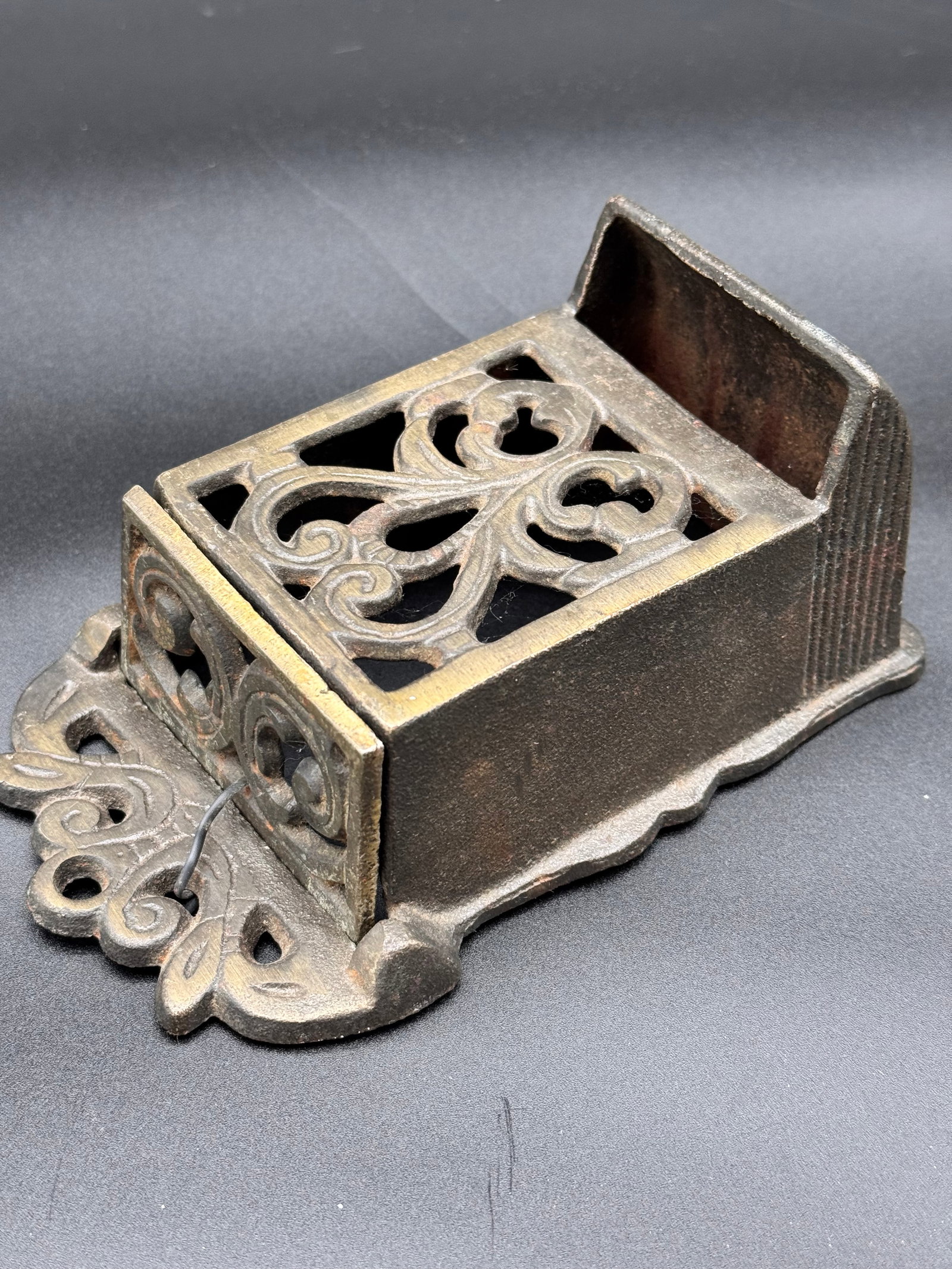 Cast Iron Wall-Mounted Matchbox Holder / Match Safe: Wall mounted cast iron matchbox holder in perfect condition. Also known as a match safe. Features scrollwork with a flip top, lidded top.