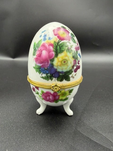 Floral Hinged Porcelain Egg: Vintage floral porcelain egg-shaped trinket box with a gold tone hinged clasp and three delicate feet. Featuring a colorful rose and floral bouquet design typically created using a transfer method on 
