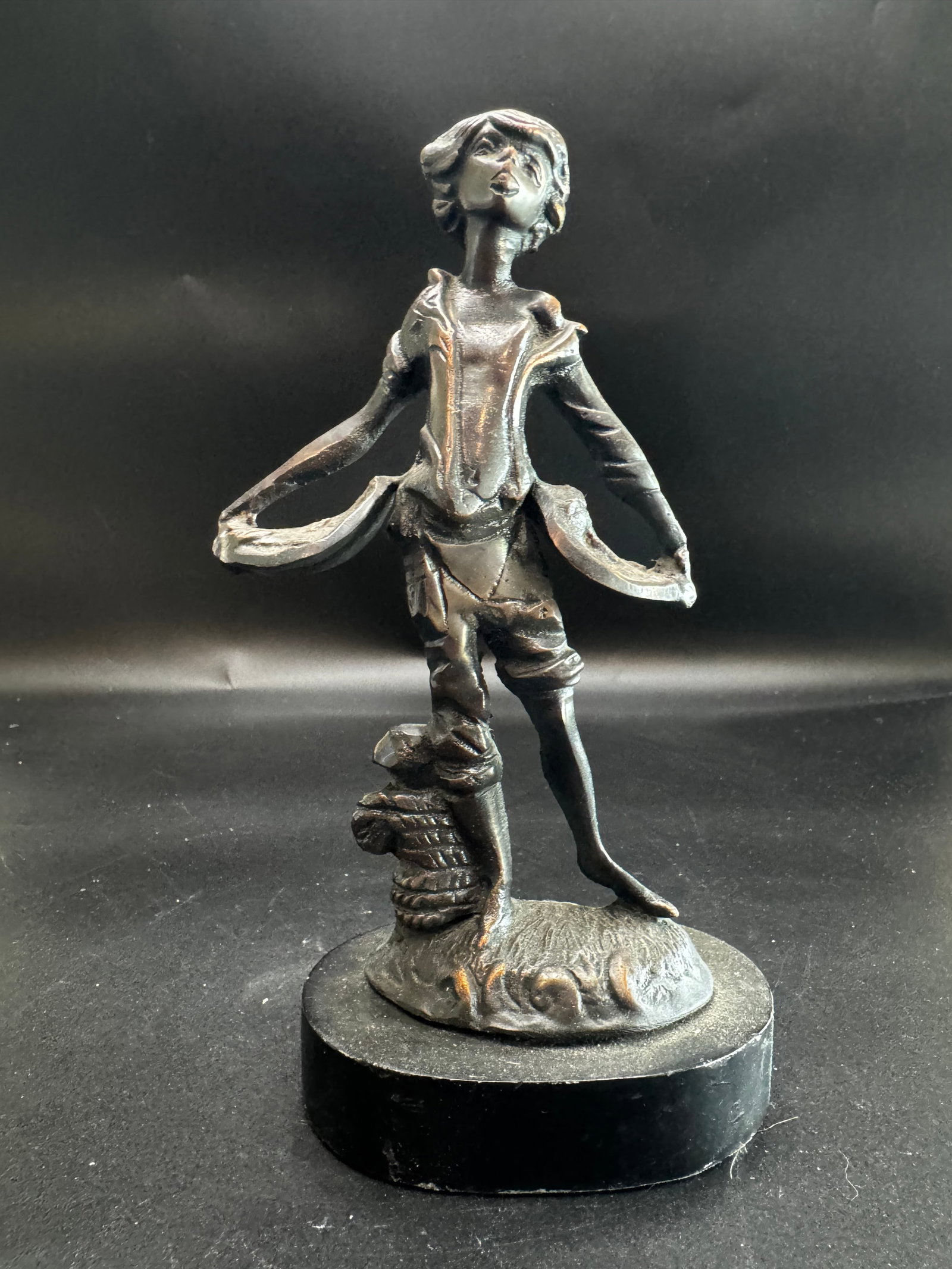 Vintage Bronze Fishmonger Statue: Cast copper or bronze figurine featuring a dark patina on a mounted base.