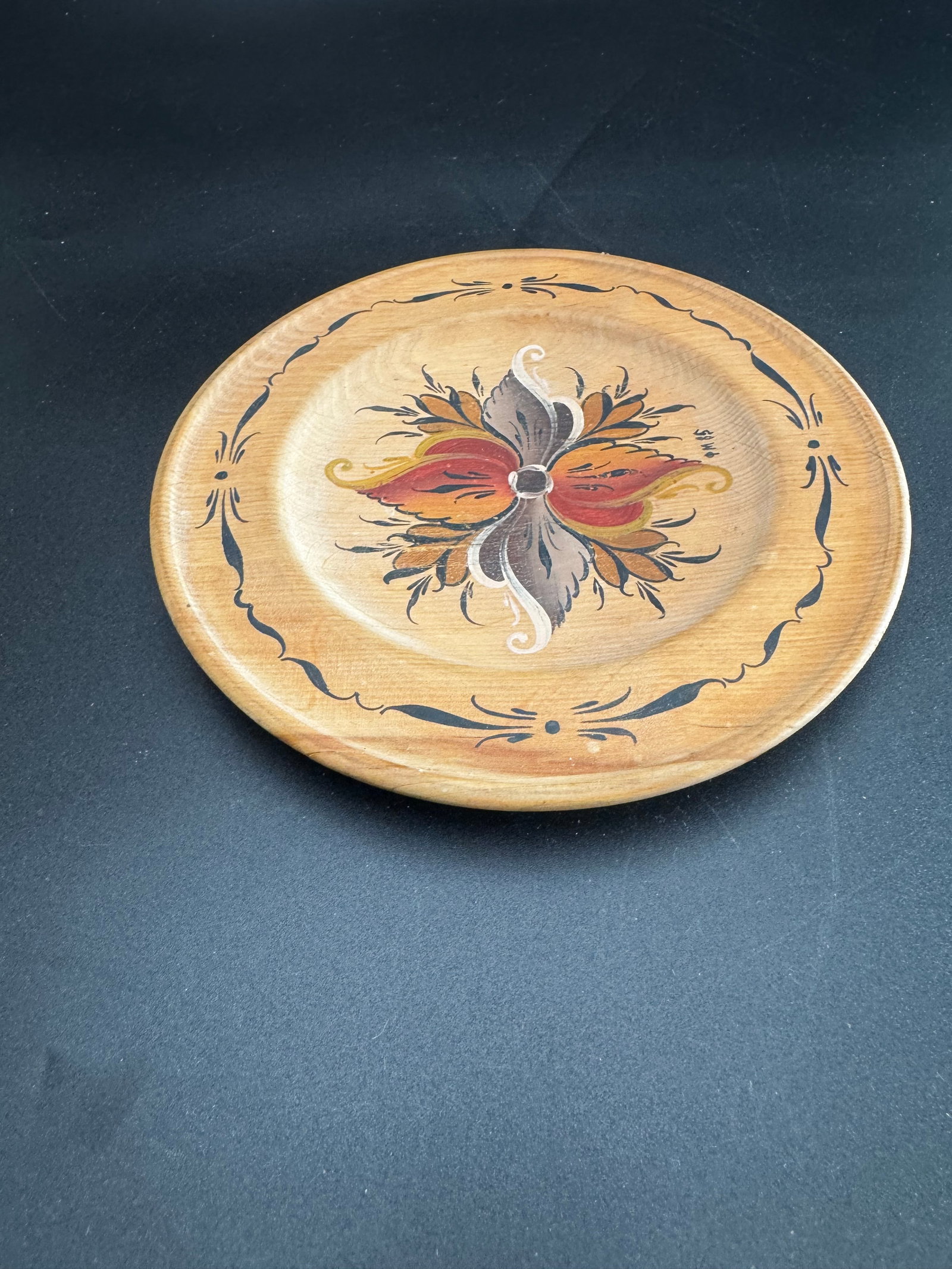 Hand Painted Wood Dish: Wooden hand-painted plate featuring a colorful floral design and dark border.