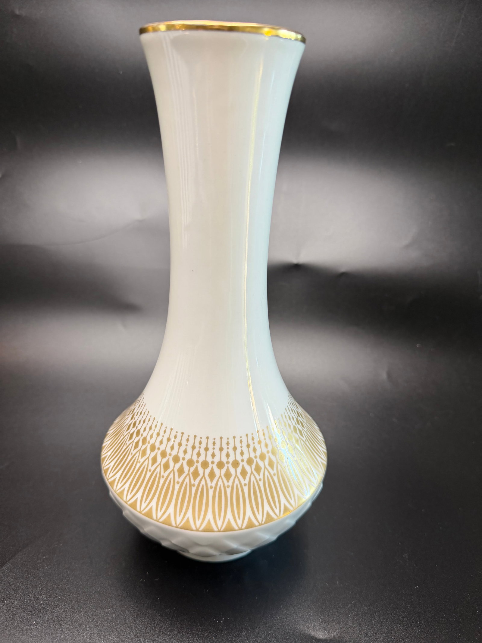 Rosenthal Germany "Noble" Porcelain Vase: Vintage mid century modern porcelain vase manufactured in West Germany during the 1960s . The vase showcases a classic gloss white glaze, accented with an intricate, geometric gold gilt band around th