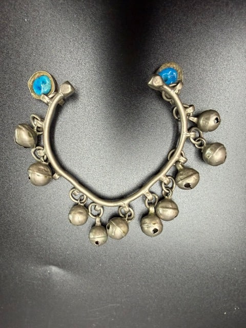 Vintage Coin Silver Ethnic Bangle With Dangling Silver Tone Bells: The stones appear to be natural red garnets, frequently listed as Mozambique garnet or similar varieties known for their deep red color. These loose gemstones are typically purchased for handmade jewe