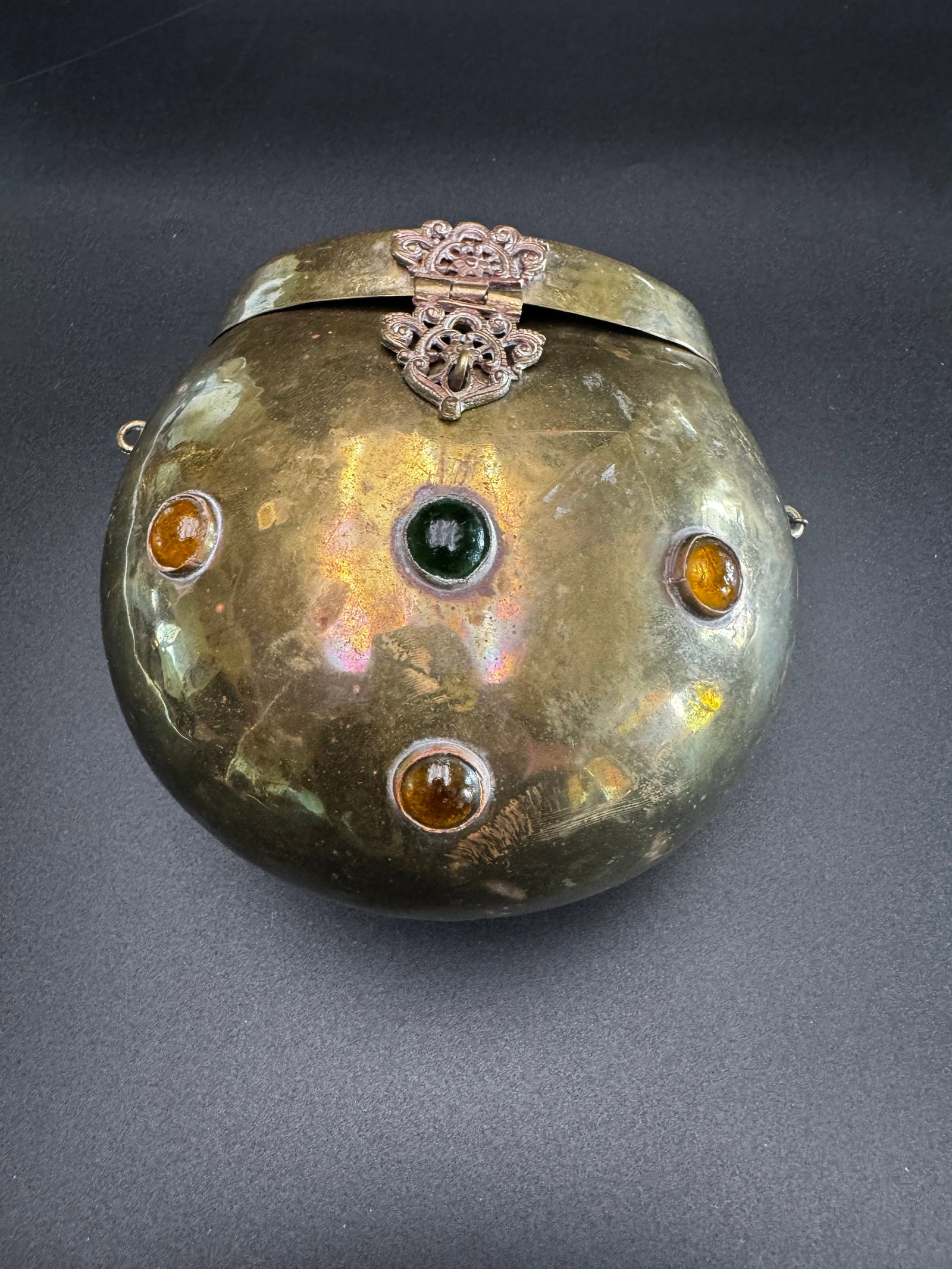 Bohemian style brass clutch: Decorated with round glass gemstones, and a brass clasp in the shape of a fig tree. The interior is lined with purple velvet. Absolutely stunning vintage accessory! Bohemian style brass clutch,