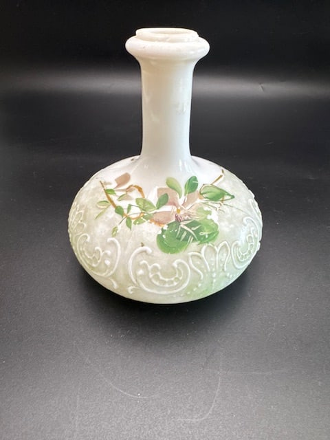 Late Victorian / Early Edwardian Satin Glass Bud Base or Barber Bottle: Typically made between 1885 and 1915. The white bud vase or barbers bottle features the remnants of a pale green satin finish and hand-painted floral designs along with raised white enamel