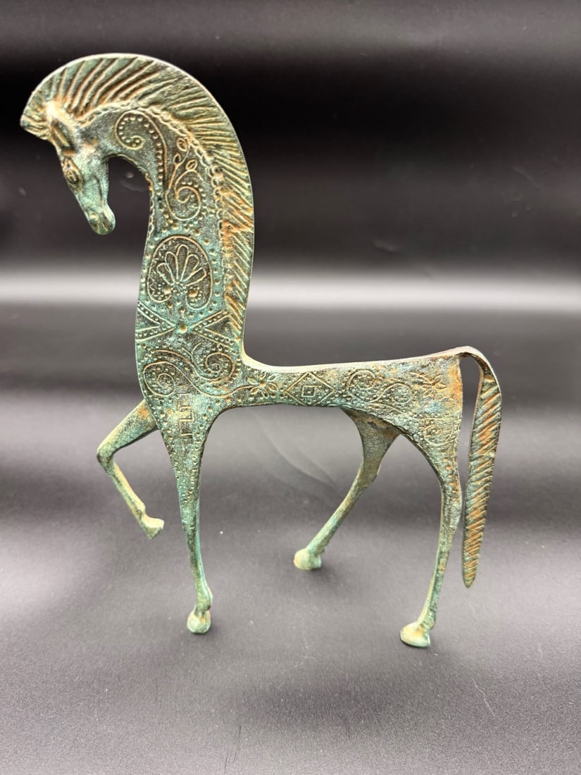 Bronze Greek Horse Statue: This is a bronze Greek horse statue figurine with a verdigris patina. Handcrafted in Italy. Stylized elongated horse with openwork decoration with scrolls, rosettes and geometric motifs. Long arched