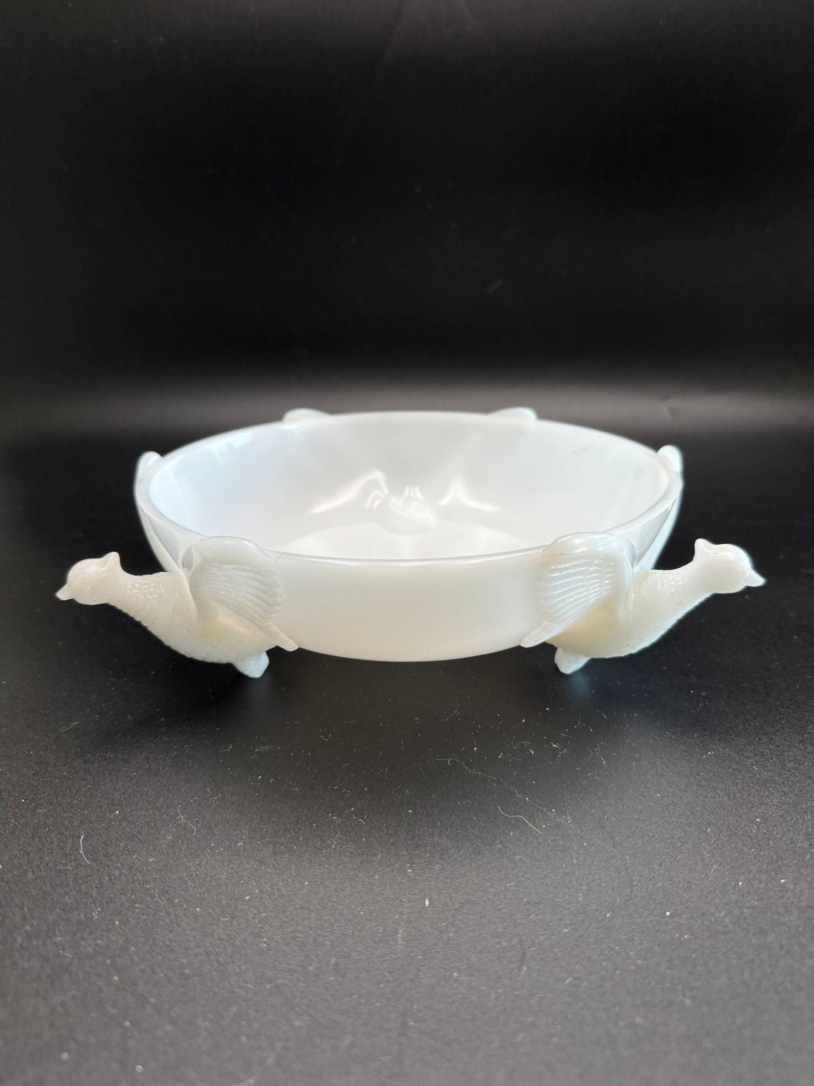 Vintage Jeannette Glass Milk Glass Bowl: This vintage Jeannette Glass milk glass bowl features three sculpted pheasant birds acting as feet and handles. Scalloped rim, 3 molded bird feet supporting the bowl, raised feather motifs on sides,