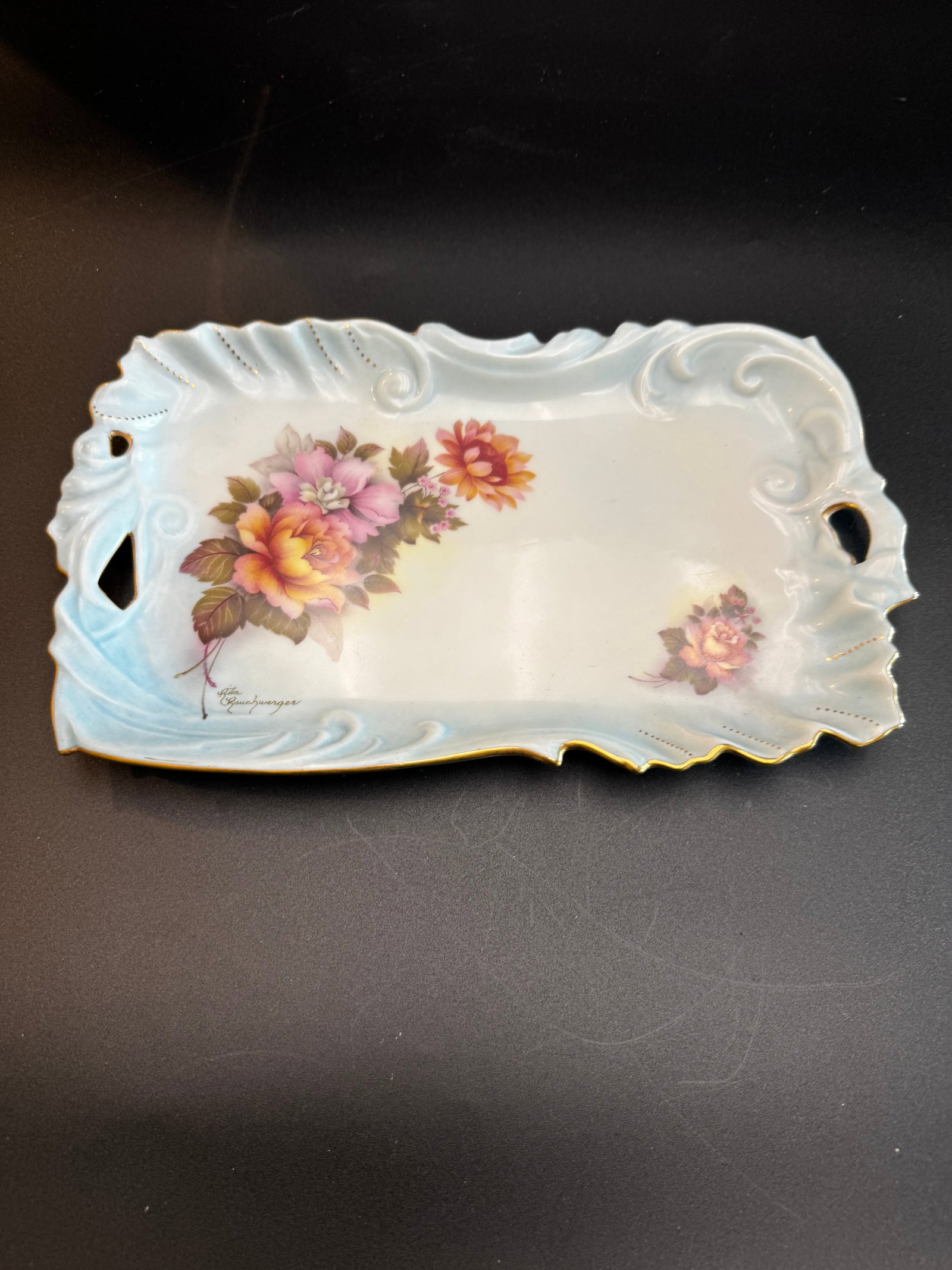 Antique Hand-Painted RS Prussia Porcelain Tray / Vanity Tray: This antique RS Prussia porcelain tray from featured artist Rita Rauchwerger. This hand-painted pink and yellow roses with gold gilt trim. She specialized in creating meticulously hand-painted fine