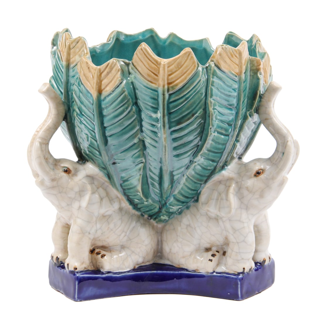 Majolica Style Elephant Centerpiece Bowl: A majolica style colorful glazed centerpiece bowl depicting three elephants supporting a leaf shaped vessel. 10 w, 10.5 h inches.