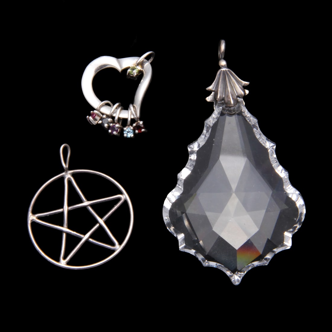 Lenox Sterling Silver and Gemstone Pendant and More: A collection of three sterling silver pendants. One Star shaped pendant marked "STER", with a weight of 3 grams. One Lenox sterling and gemstone charm pendant, marked "LENOX 925 STERLING", with a