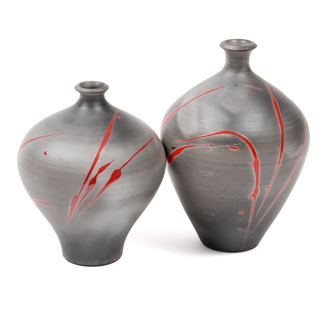 Pair of Bob Reiberg Ceramic Vases: A pair of ceramic vases by potter Bob Reiberg, these vases feature a grey form with a red splatter design. 5.5w, 8.5h inches (of largest piece)